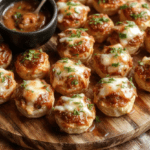 Colorful spread of Super Bowl appetizers on a wooden board: golden nachos with melted cheese and jalapeños, crispy buffalo wings with red sauce, jalapeño poppers with visible cheesy centers, mini beef sliders on brioche buns, and fresh veggie cups with ranch dip. Natural light, vibrant textures, shallow depth of field, no text.